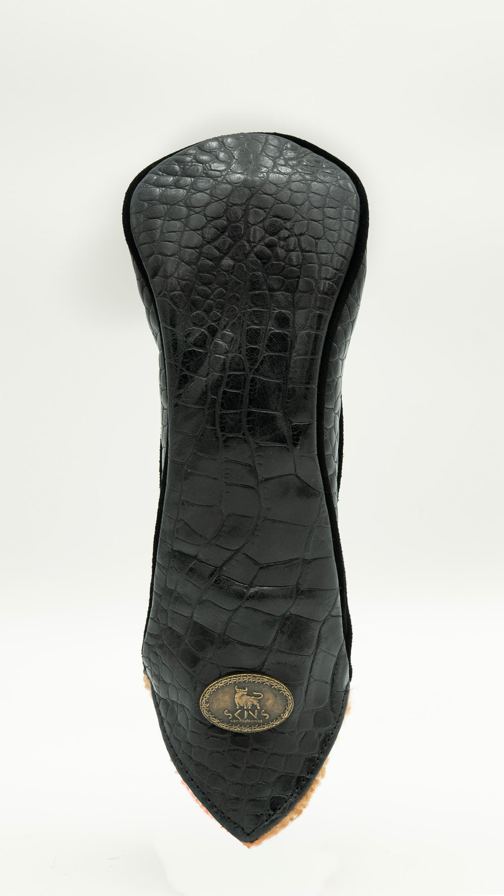 A black crocodile-embossed leather golf club headcover shown from the back, featuring a gold oval logo badge near the pointed tip, set against a plain white background.