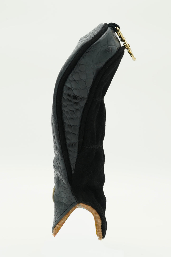 A black and dark gray textured leather boot cover with a gold zipper pull, shown from a side profile view against a white background.