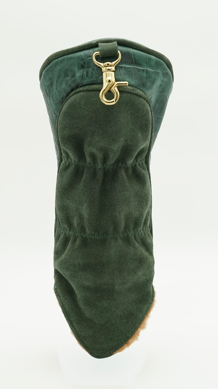 A dark green velvet boot cover with a gold-tone metal clasp, shown on a plain white background.
