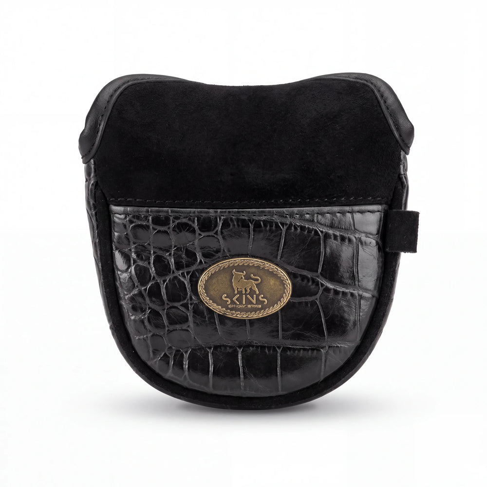 Black leather camera pouch with a crocodile-embossed front panel, black suede top flap, and a gold oval metal logo plate on a white background.