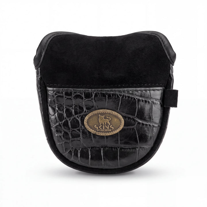 Black leather camera pouch with a crocodile-embossed front panel, black suede top flap, and a gold oval metal logo plate on a white background.