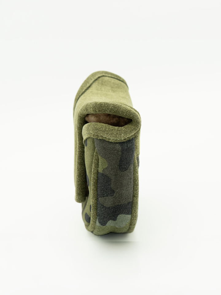 A close-up side view of a small olive green camouflage fabric pouch or sleeve on a clean white background.