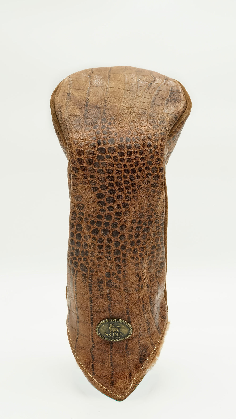 A brown crocodile-embossed leather golf club headcover on a clean white background, featuring a small oval brass logo badge near the bottom tip.
