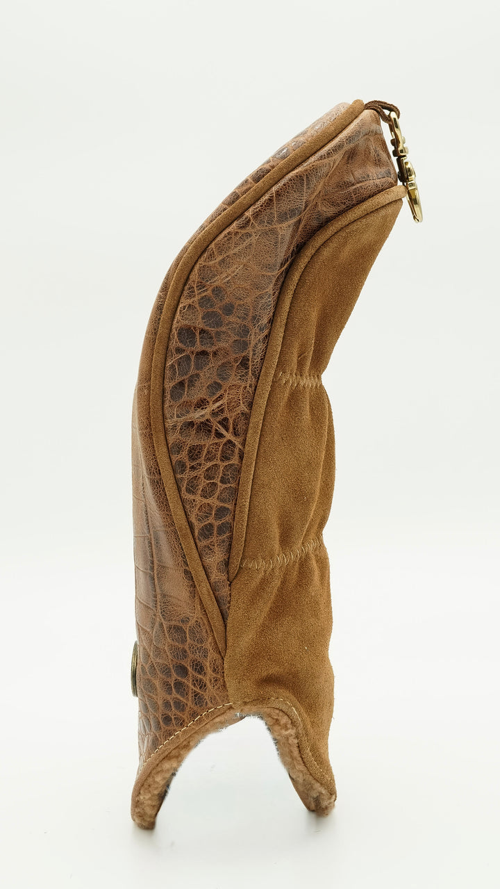 A brown leather boot with a textured crocodile-patterned side panel and a gold-tone zipper pull, shown from a side profile on a white background.
